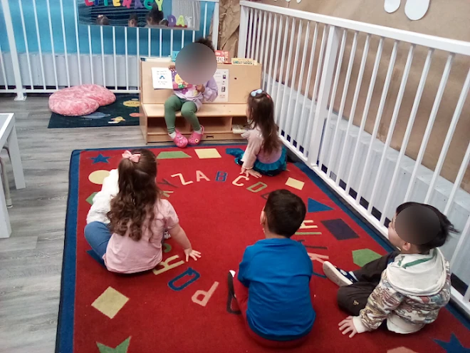 Children reading together during a Village Scholars Preschool childcare routine